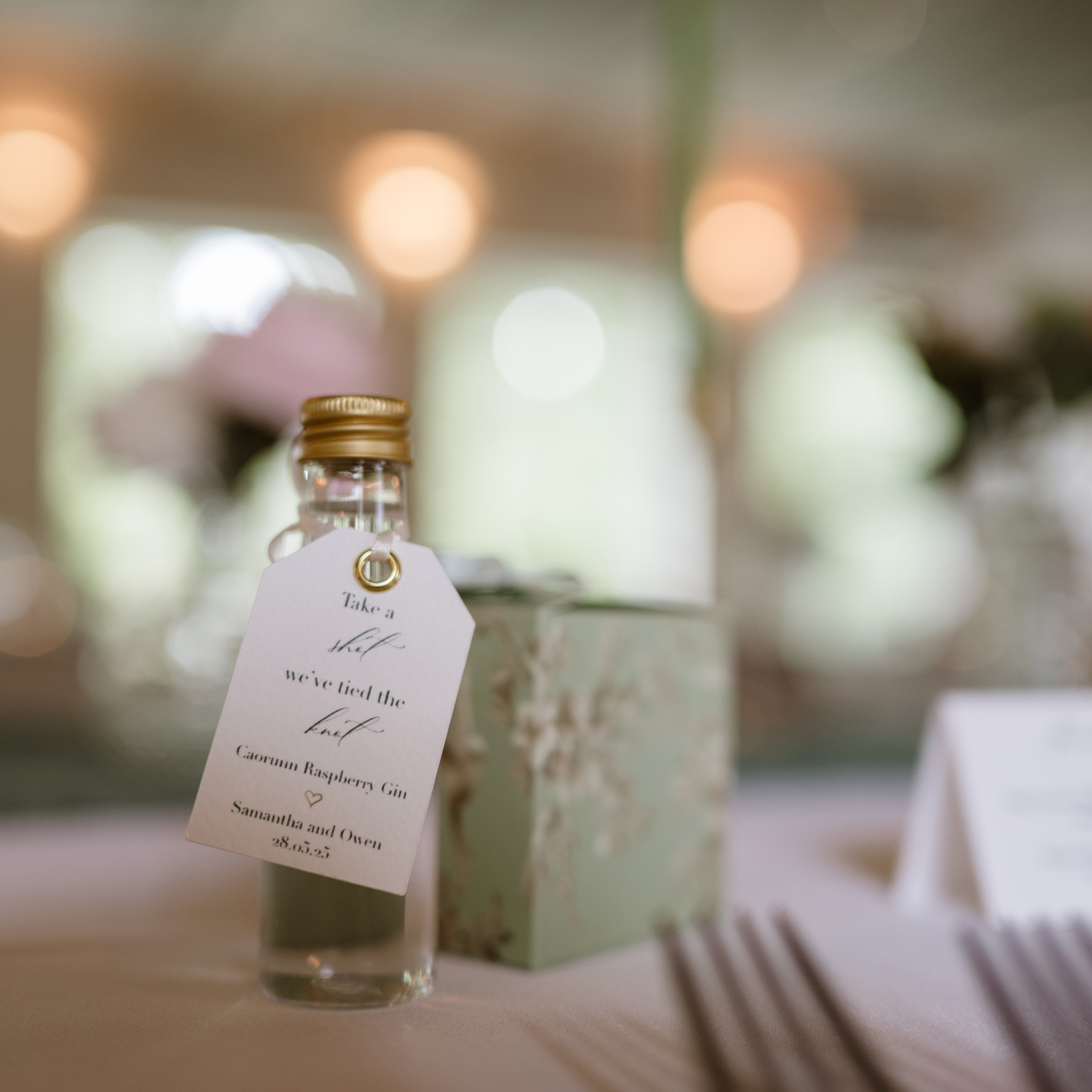Small favour bottle with a label on a blurred background