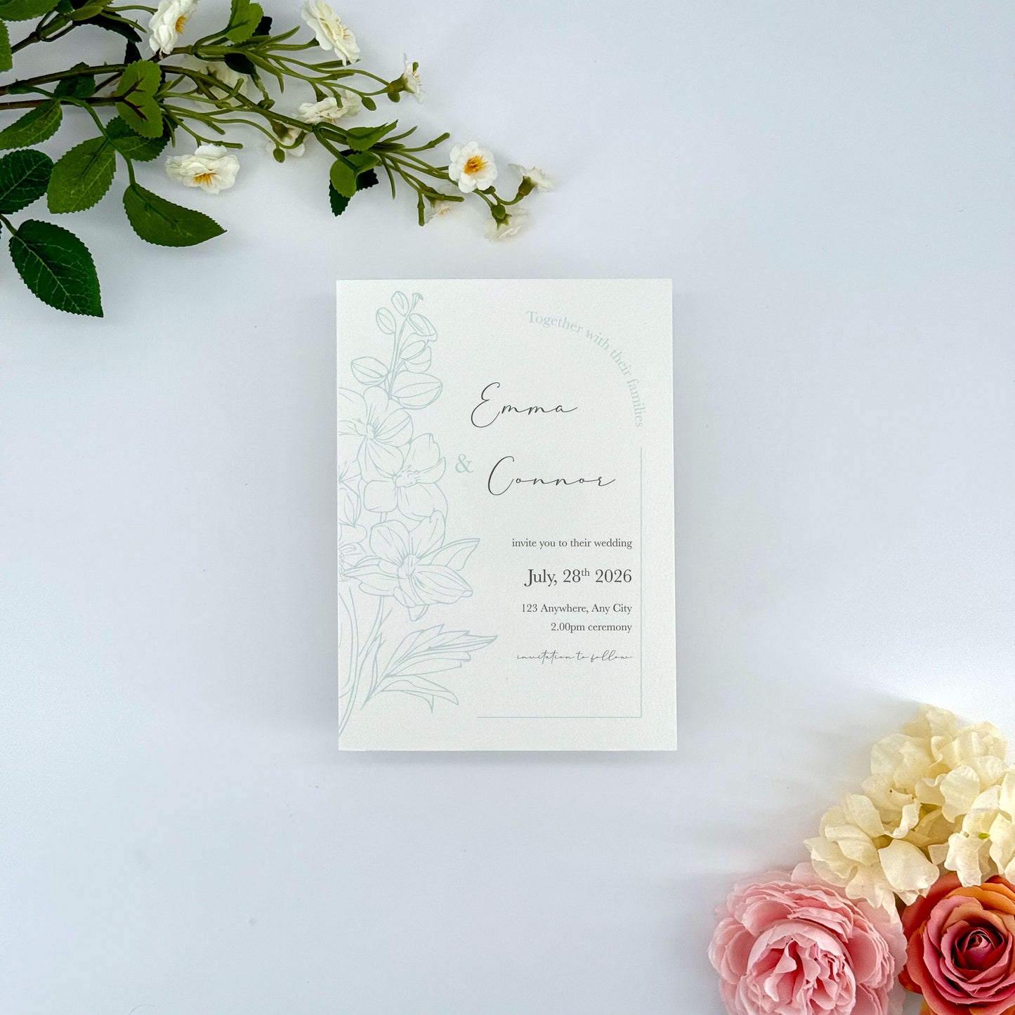 Wedding invitation card with floral design on a light background