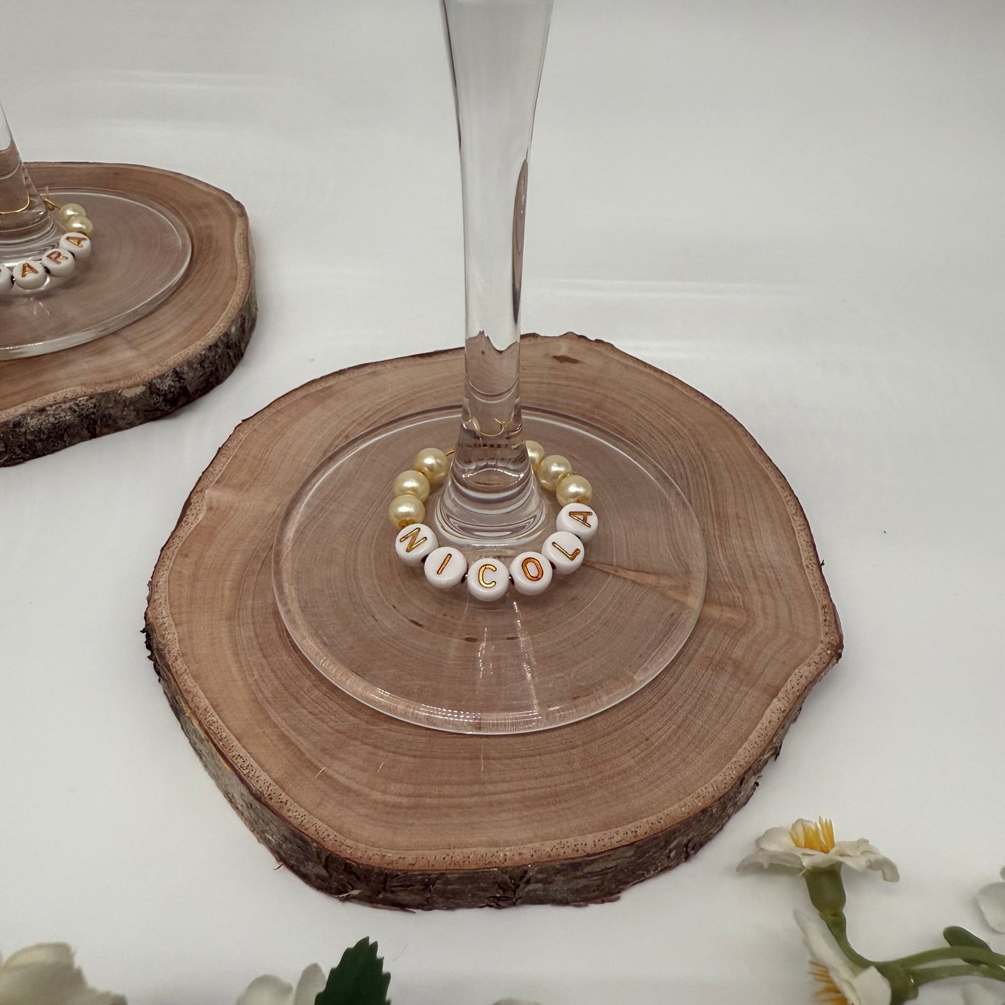 Wine glass with a decorative ring on a wooden coaster