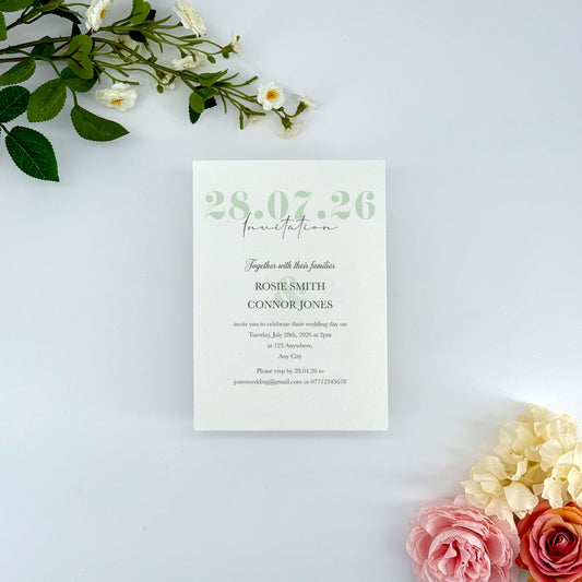 Wedding invitation card with floral decorations on a light background