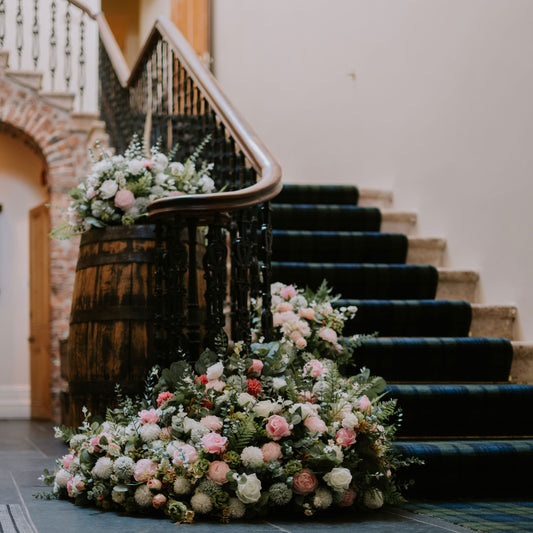 Decorative floral arrangements on a staircase in an elegant interior setting.